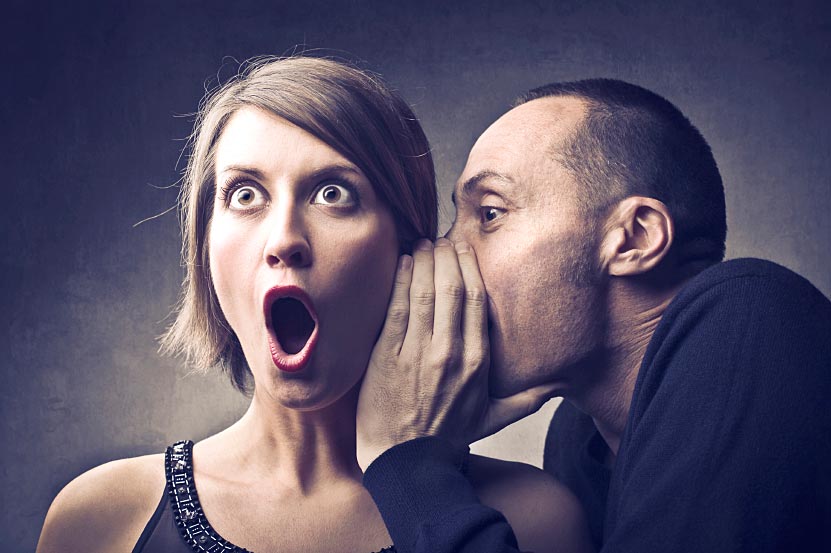 Man Whispering in Woman's Ear